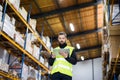 Male warehouse worker with tablet.