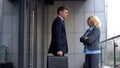 Young male worker apologizing strict female boss for being late, work conflict Royalty Free Stock Photo