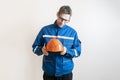 a young male worker holding a helmet, industrial safety equipment Royalty Free Stock Photo