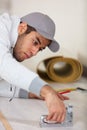 young male worker installing floor at home Royalty Free Stock Photo