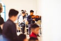 Young males playing violin at a church service in Zacatecas, Mexico
