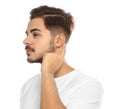 Young man adjusting hearing aid Royalty Free Stock Photo
