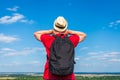 Young man admiring beautiful view of the forest landscape rear view.Young man standing alone summer day outdoors Royalty Free Stock Photo