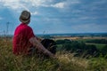 Young man admiring beautiful view of the forest landscape rear view.Young man standing alone summer day outdoors Royalty Free Stock Photo