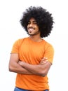 Young man with afro smiling against white background