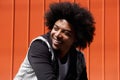 Young man with afro smiling and looking away