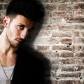 Young man against brick wall Royalty Free Stock Photo