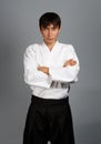 Young man in aikido uniform in serious pose