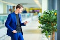 Young man in airport with baggage waiting boarding Royalty Free Stock Photo