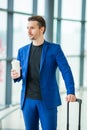 Young man in airport. Casual guy with luggage in international airport Royalty Free Stock Photo