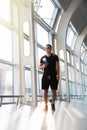 Young man in airport. Young man using smartphone smiling happy inside building of airport Royalty Free Stock Photo