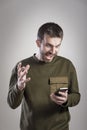 Man angry at his phone, outraged and enraged Royalty Free Stock Photo