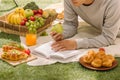 Young man with apples lies on green grass and reads book. Royalty Free Stock Photo