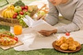 Young man with apples lies on green grass and reads book. Royalty Free Stock Photo