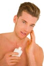 Young man applying aftershave Royalty Free Stock Photo