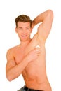 Young man applying deodorant Royalty Free Stock Photo