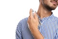 Young man applying perfume on white background Royalty Free Stock Photo