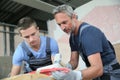 Young man apprentice with instructor in masonry