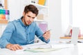 Young man architect holding ruler over diagram on the desk Royalty Free Stock Photo