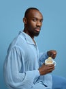 Young man as a medieval grandee on blue background