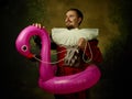 Young man as a medieval knight on dark background