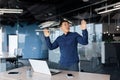 Young man Asian businessman dancing in the office, celebrating victory, successful deal, promotion Royalty Free Stock Photo