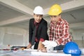 Young man asian engineers were consulted together and plan in construction site Royalty Free Stock Photo