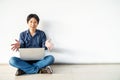Young man asian sitting on the floor with using computer laptop smiling proud and self-satisfied in my works posing isolated Royalty Free Stock Photo