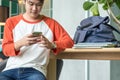 Young man asian teenager using mobile phone chatting with friend