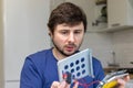 Young man assembles electronic computer components with his own hands. Hobby, technician, do-it-yourself assembly and invention Royalty Free Stock Photo