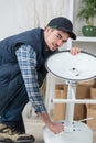 Young man assembling stool Royalty Free Stock Photo