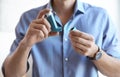 Young man with asthma inhaler indoors Royalty Free Stock Photo