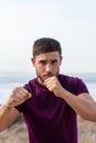 Young man athlete with arms raised in fighting position outdoor Royalty Free Stock Photo