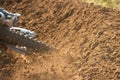 A young man, a man, an athlete, driving a motocross motorcycle in the blur, on a dirt track. Movement, blur, slow-motion Royalty Free Stock Photo