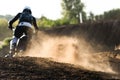 A young man, a man, an athlete, driving a motocross motorcycle in the blur, on a dirt track. Movement, blur, slow-motion Royalty Free Stock Photo