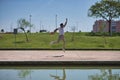 Young man, attractive and Hispanic, wearing a white t-shirt and hat, jumping in the air very happy, in an outdoor park. Concept,