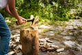 Young man with axe chopping wood on a chopping block Royalty Free Stock Photo