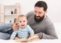 Father and reading book to little baby Royalty Free Stock Photo