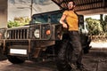 Young man on background army Hummer off road car