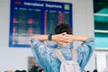 Young man with backpack in airport looking to flight timetable Royalty Free Stock Photo