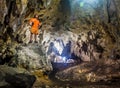 Young man with backpack exploring cave