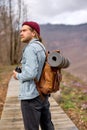 Young man with backpack exploring nature in spring, walking alone outdoors Royalty Free Stock Photo