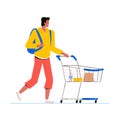 Young man with a backpack goes with a trolley in the store. The guy buys groceries. Supermarket shopping concept