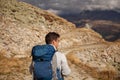 Young man with backpack hiking in the mountains. Hiking concept Royalty Free Stock Photo