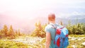 Young man with backpack hiking in the mountains Royalty Free Stock Photo