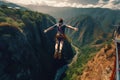 A young man with a backpack jumps from a cliff into the abyss, Extreme Bungee jumping on the mountain, top view, no visible faces Royalty Free Stock Photo