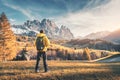 Young man with backpack and mountains at sunset Royalty Free Stock Photo