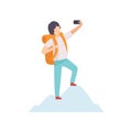 Young Man with Backpack Taking Selfie Photo on Smartphone while Standing on Top of Mountain, Guy Making Photo or Video Royalty Free Stock Photo