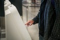 Young man with backpack touching interactive display using self service machine, doing self-check-in for flight or Royalty Free Stock Photo