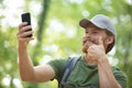 young man with backpack using smart phone on beautiful nature Royalty Free Stock Photo